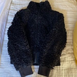 Black fluffy jacket.